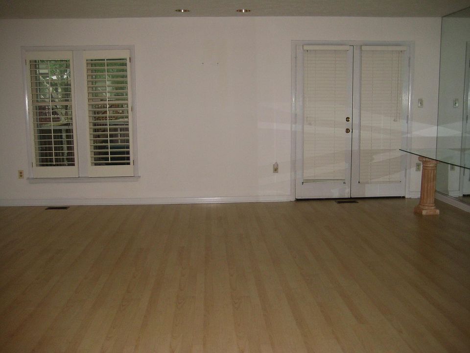 Plantation shutters and french doors leading to deck