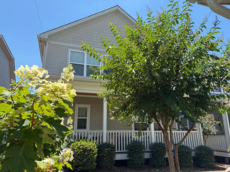 The back porch faces a shared courtyard area. The home is one of 9 in a small HOA.