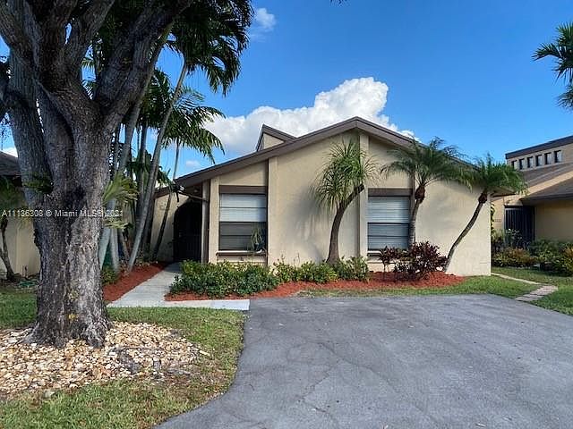 Front of house dead end street, lots of lush landscape