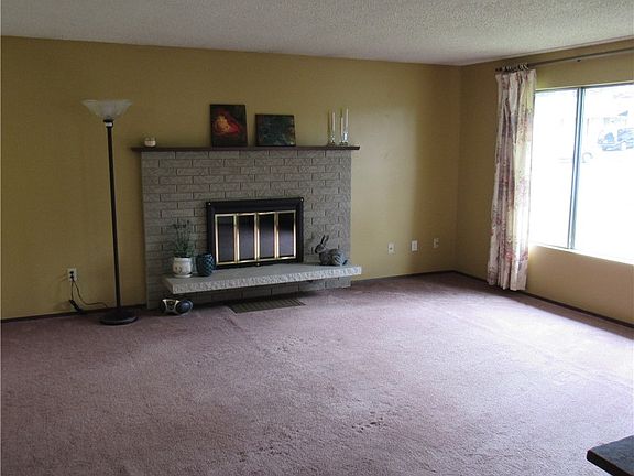 Upstairs Living area with wood burning fireplace, large windows for natural light