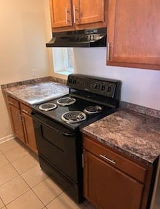 Vacant kitchen unit cabinetry and appliances