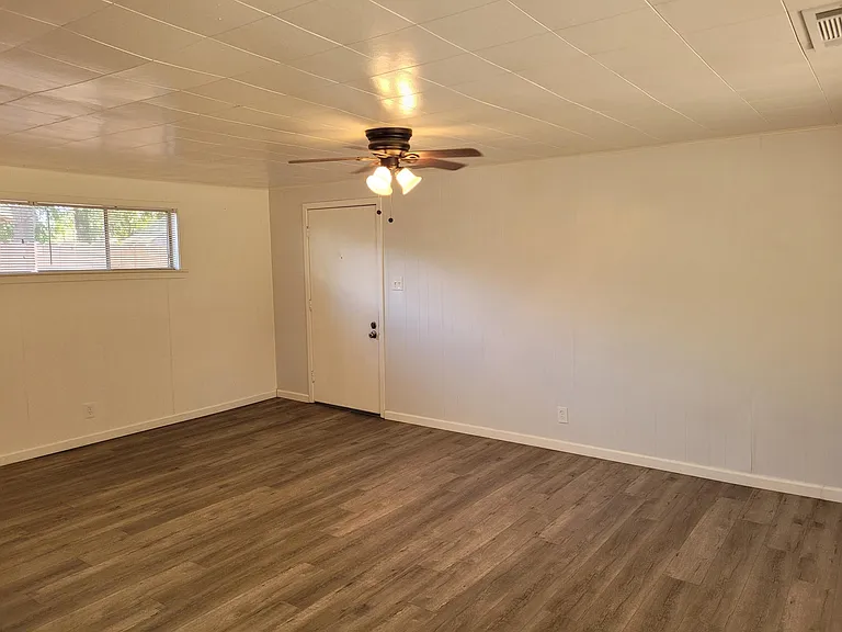 Living area view from kitchen. Doorway to attached carport.