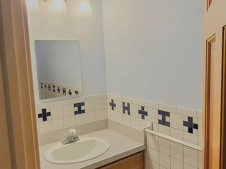 Hall-way accessible half-bathroom.