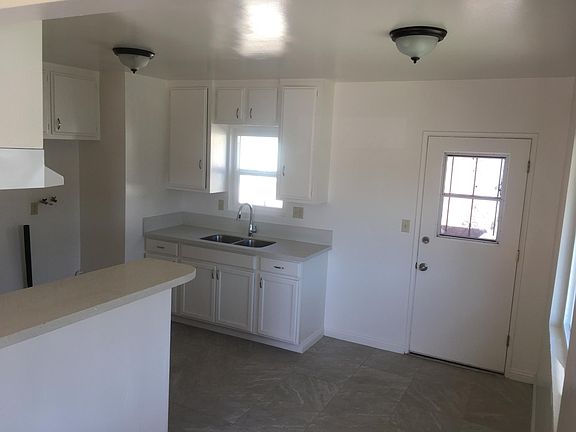 Kitchen. New flooring, new counter tops, repainted cabinets, stackable washer & dryer hookups.