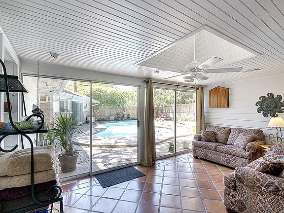 Fantastic Sunroom air conditioned with Tile floors, fan, & skylight w/inviting views of pool and yar