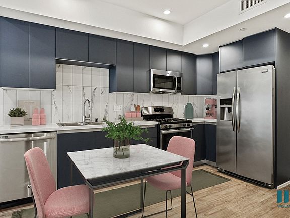Kitchen with Stainless-Steel Refrigerator, Dishwasher, Stove, and Microwave Oven
