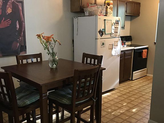 Dining area before new flooring installed. Included for size/perspective only.