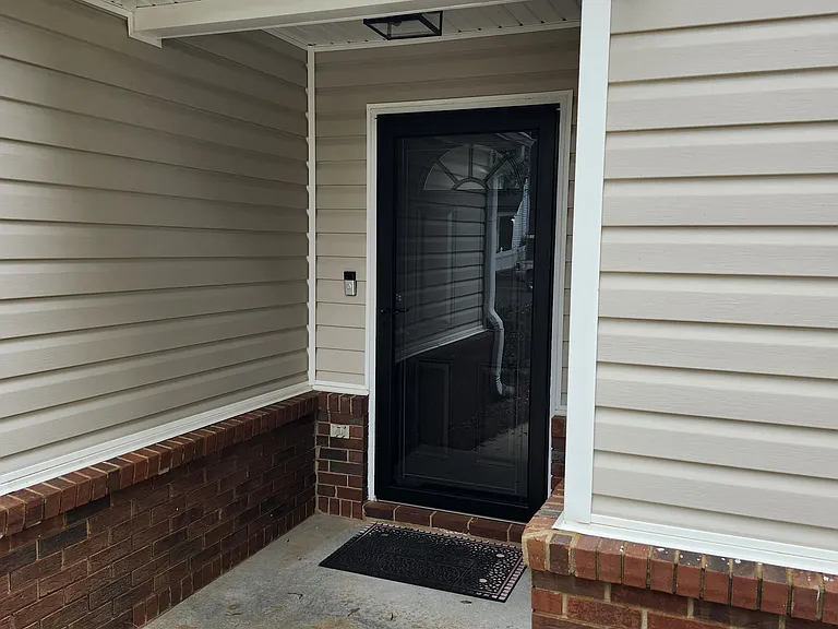 Front porch entrance; New (black) entrance light; keypad and key access available.