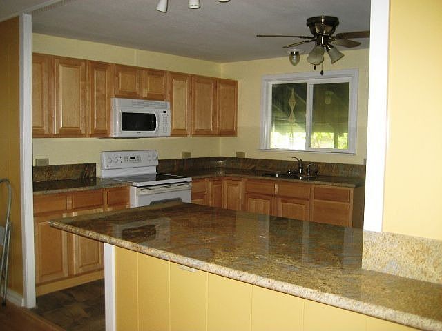 Remodeled Kitchen with Granite, Maple Cabinets & Tile flooring.