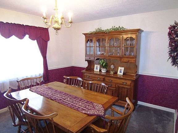 Pleasant dining rm has wainscot