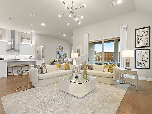 REPRESENTATIVE PHOTO - Open living space in in the Rapport home plan by Trophy Signature Homes