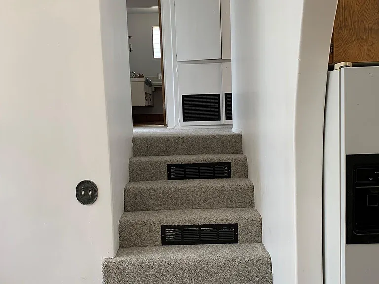 Stairway up to three bedrooms including master