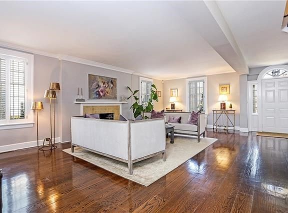 Sun drenched Living Room with restored wide plank pegged floors facing the front door.