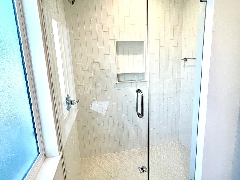 Primary Shower: Walk-in shower with designer tile, premium filtered showerhead, and great lighting and water pressure