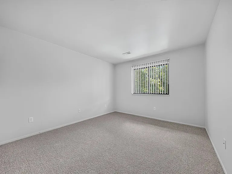 Spacious bedroom at Woodland Villa Apartments in Westland, MI.