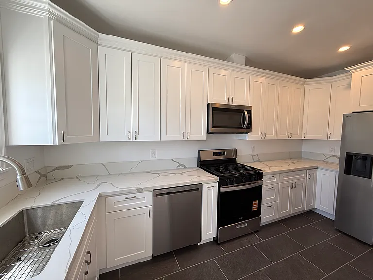 Kitchen Maximizes Cabinet Space For Dishware and Dry Goods