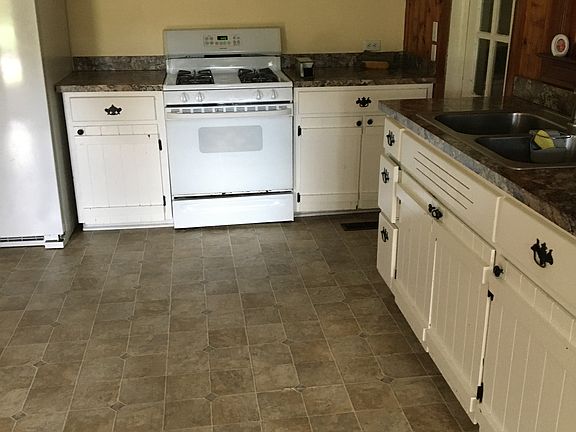 Open kitchen and Dining area. Side door leads to washer/dryer room and side patio.