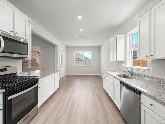 The kitchen is filled with stainless steel appliances.