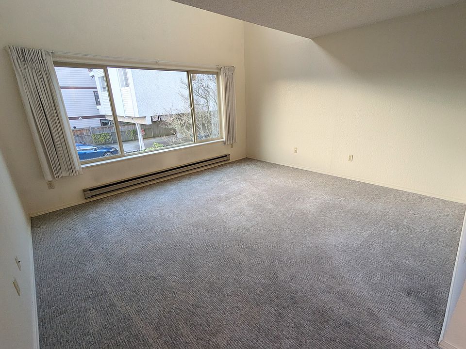 Living and dining room with west facing view. Back of building is quiet and serene!