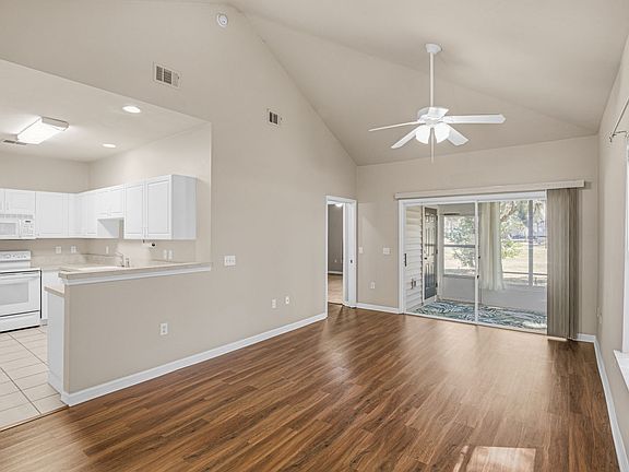 Breakfast nook toward kitchen and living room and further large sliding glass doors to porch.