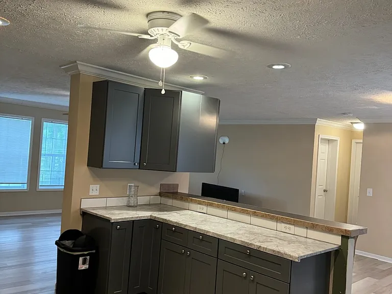 Looking past kitchen "island" into living room on left, dining room on right