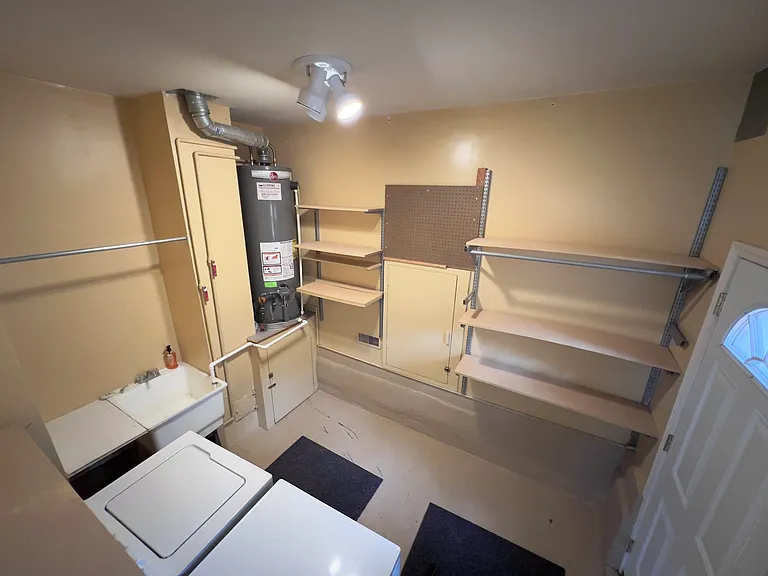 Utility Room with sink, washer, dryer, additional storage