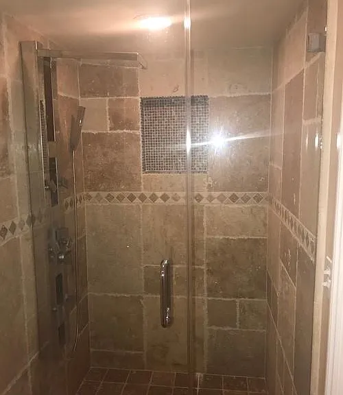 Large shower with glass doors.
