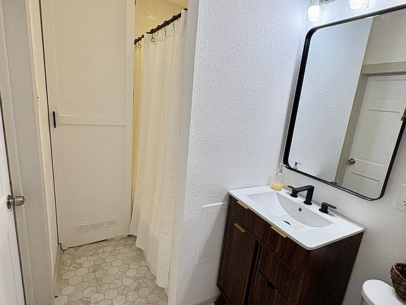 Bathroom with shower in background