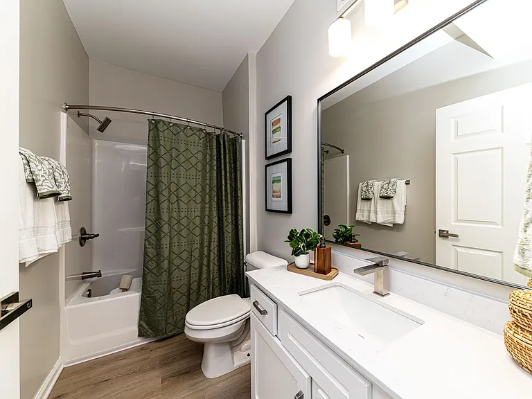 Bright bathroom with quartz counters and bathtub