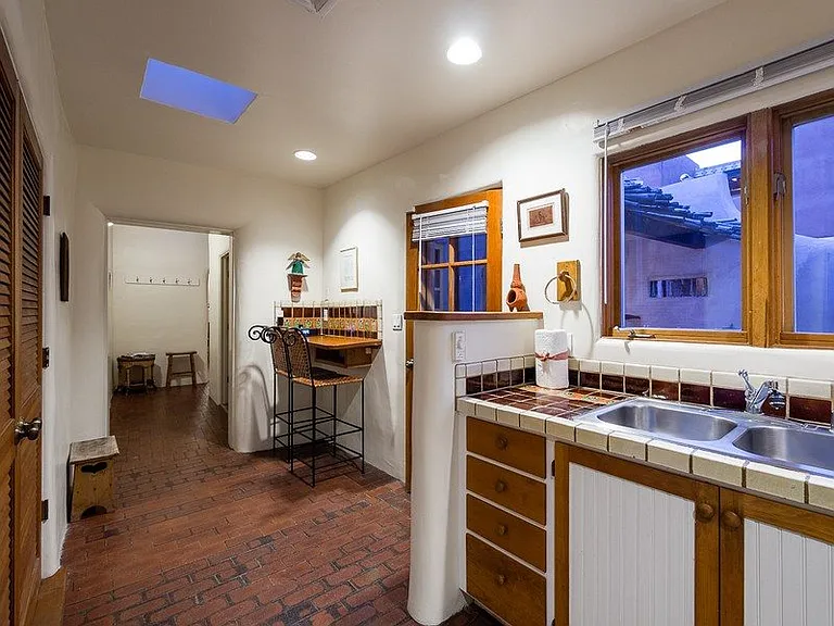 Kitchen and breakfast bar in hallway. *Full size washer & dryer are in separate closet to the left (brown door).