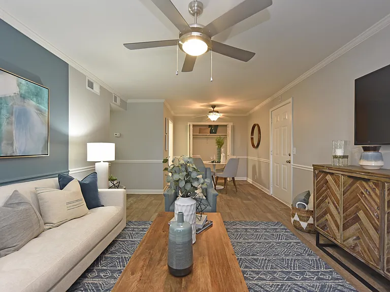 Spacious living room with hardwood-style flooring & overhead lighting
