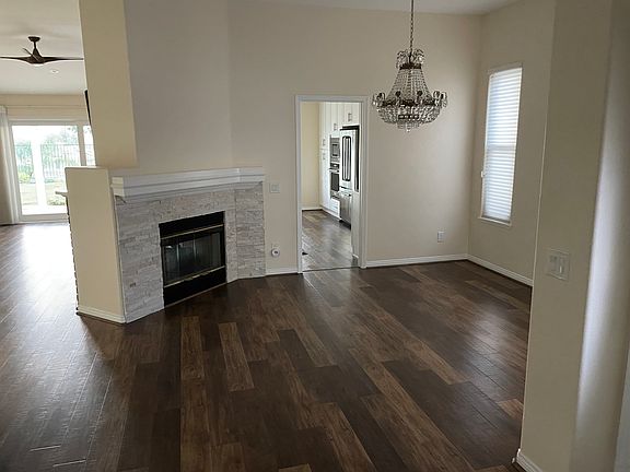 Open floor plan with two-sided gas fireplace in living and dining room