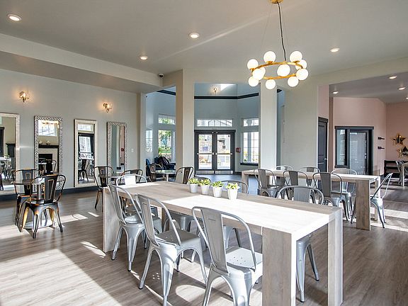 Clubhouse with hardwood-style flooring and dining table.