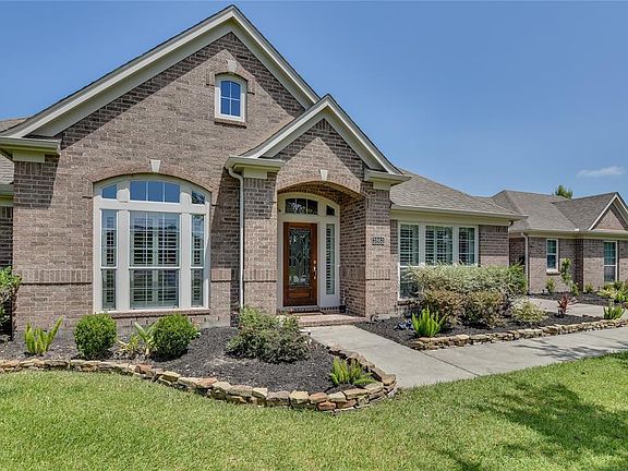 Beautiful Perry Upgraded 1 story with leaded glass front door and plantation shutters visible from the front.