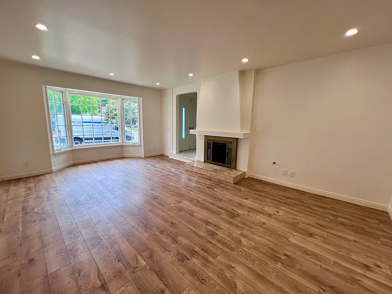Formal living room with fireplace and bay window
