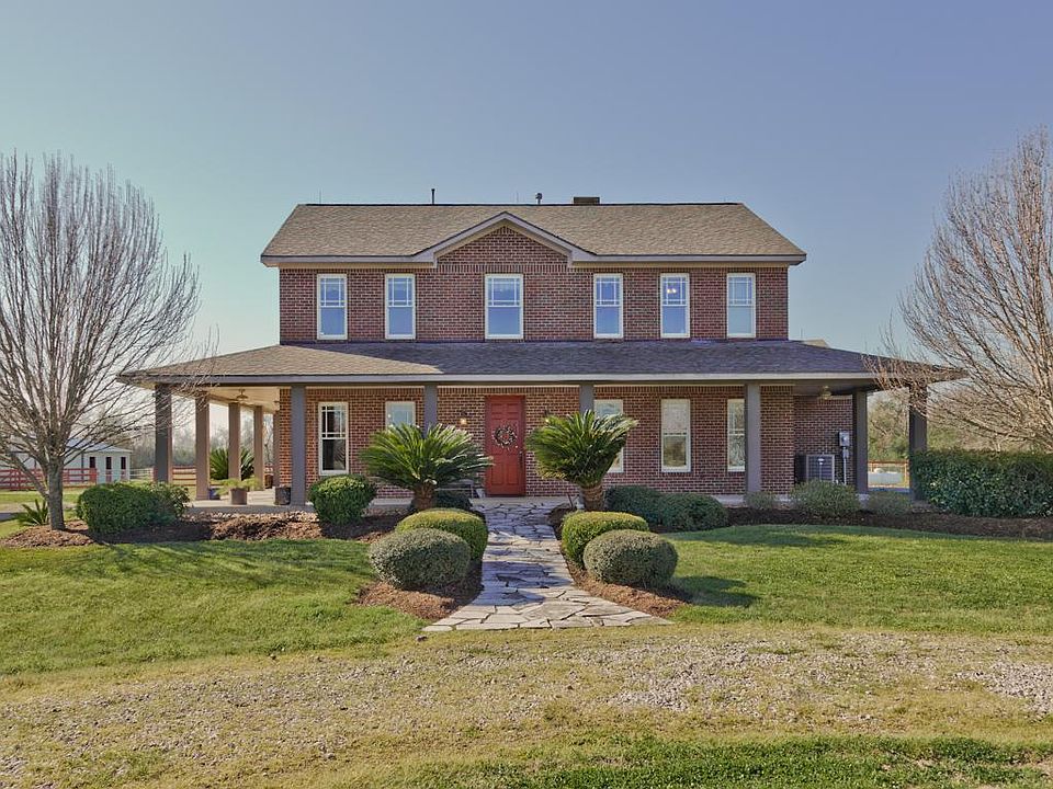 Gorgeous 2-story country home with all brick front, stone walkway, beautiful landscaping and wrap-ar