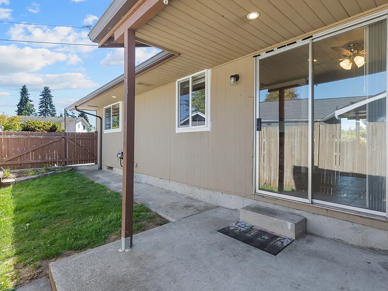 Private outdoor space maintained by tenant. Covered patio and small fenced yard.