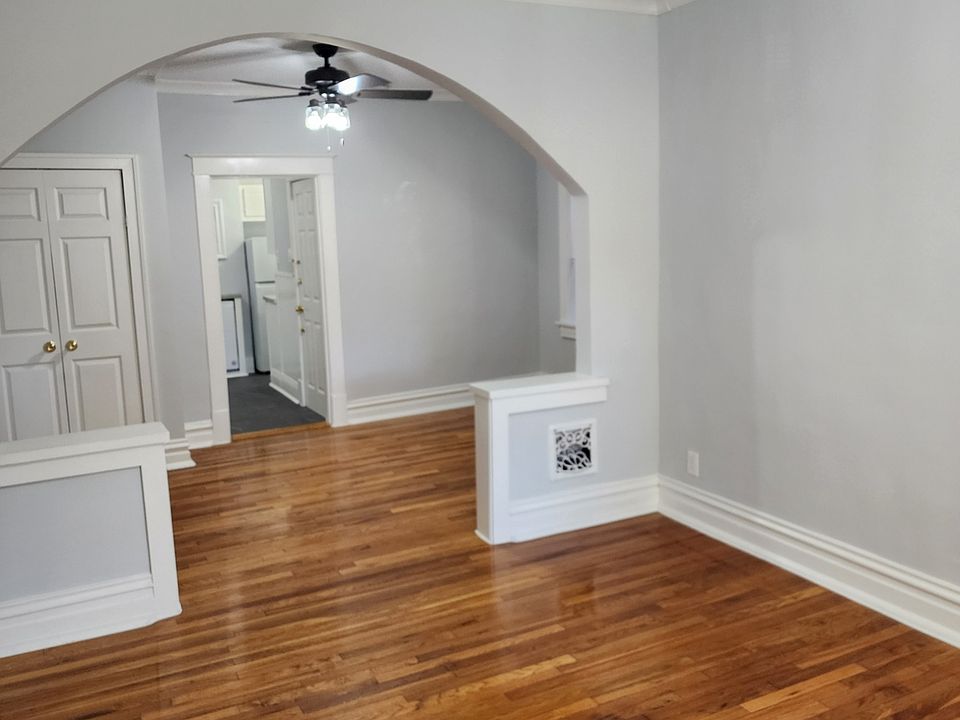 Front Room looking into the middle room. Beautiful Hardwood Floors and New Ceiling fans in both rooms