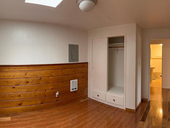 Spacious office/spare bedroom with skylight above for optimal natural lighting.
