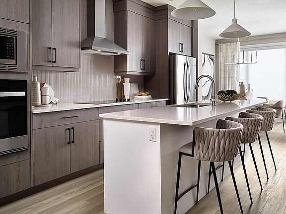 The kitchen, adorned in sleek grey and white tones, harmonizes modern style with timeless elegance
