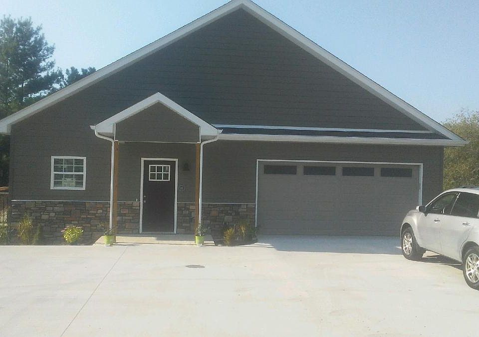 Front of building -- does not include garage space Off street parking for several cars on the left hand side. The garage space is part of the maintenance building for the entire subdivision of 28 buildings.