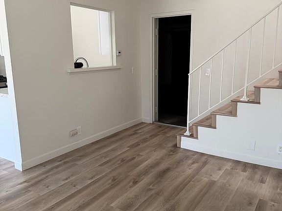 Living Room with a pass through window from kitchen and door to enter the attached double car garage