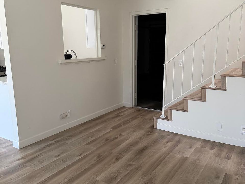 Living Room with a pass through window from kitchen and door to enter the attached double car garage