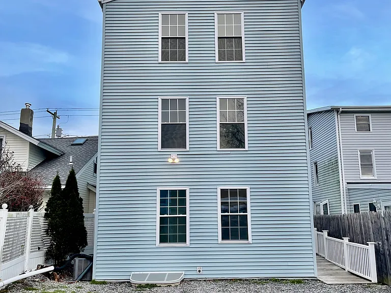Back of building with ample off-street parking and security camera