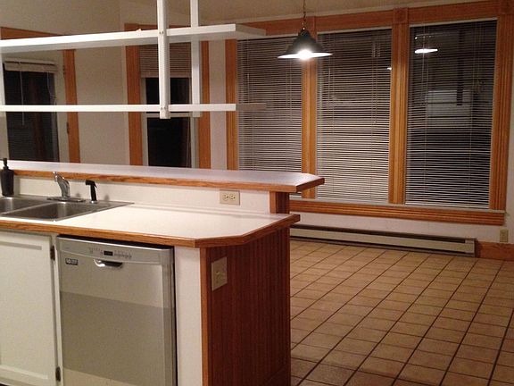 Looking from kitchen into dining area/sunroom with ceramic t