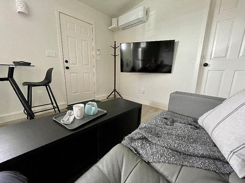 Here's a view of the "Great Room" from the loveseat. Note the front door and dining set on the left, your 50" television, A/C-heat, and fast wifi router. The coffee table also works great under the TV.