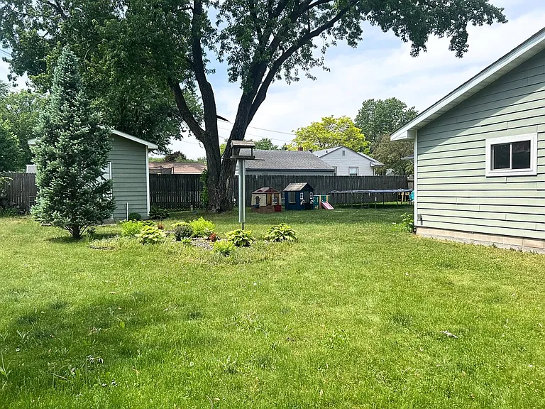 Fully fenced backyard with shed