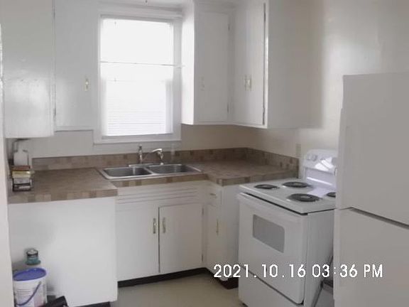 Kitchen with brand new appliances. Professionally installed new faucet, drain baskets and plumbing. Original 1948 cabinets freshly painted gloss white