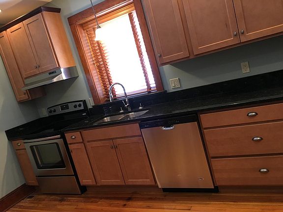 sink, dishwasher, electric stove, granite counters