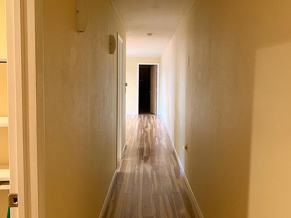 The hallway with wood floors- facing bedroom number 1.